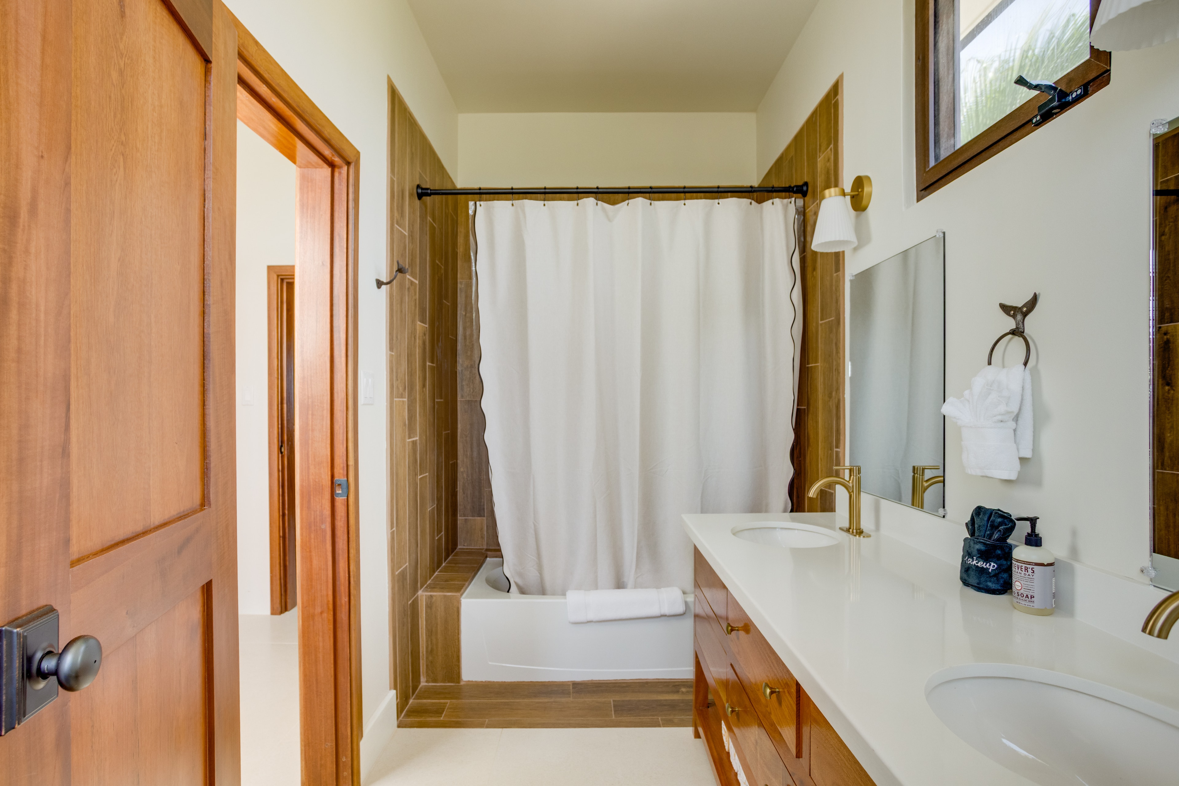 Bunk room bathroom with gold fixtures and tub/shower