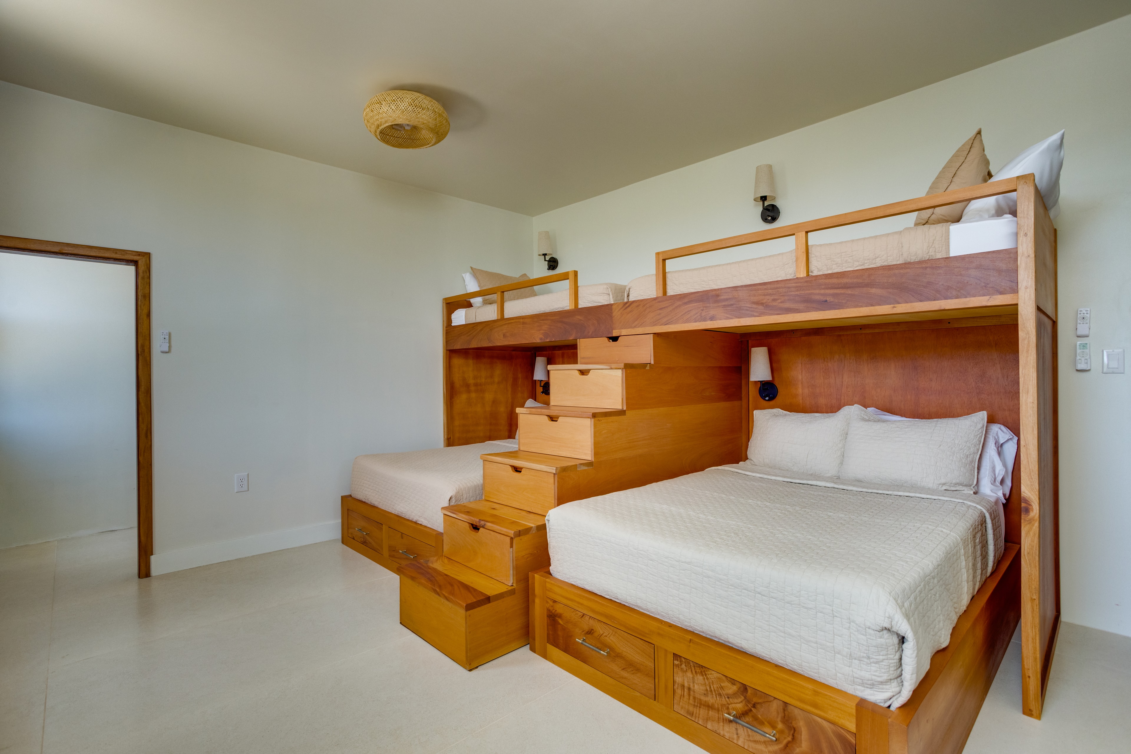 Bunk room with custom wood bunk beds and storage stairs