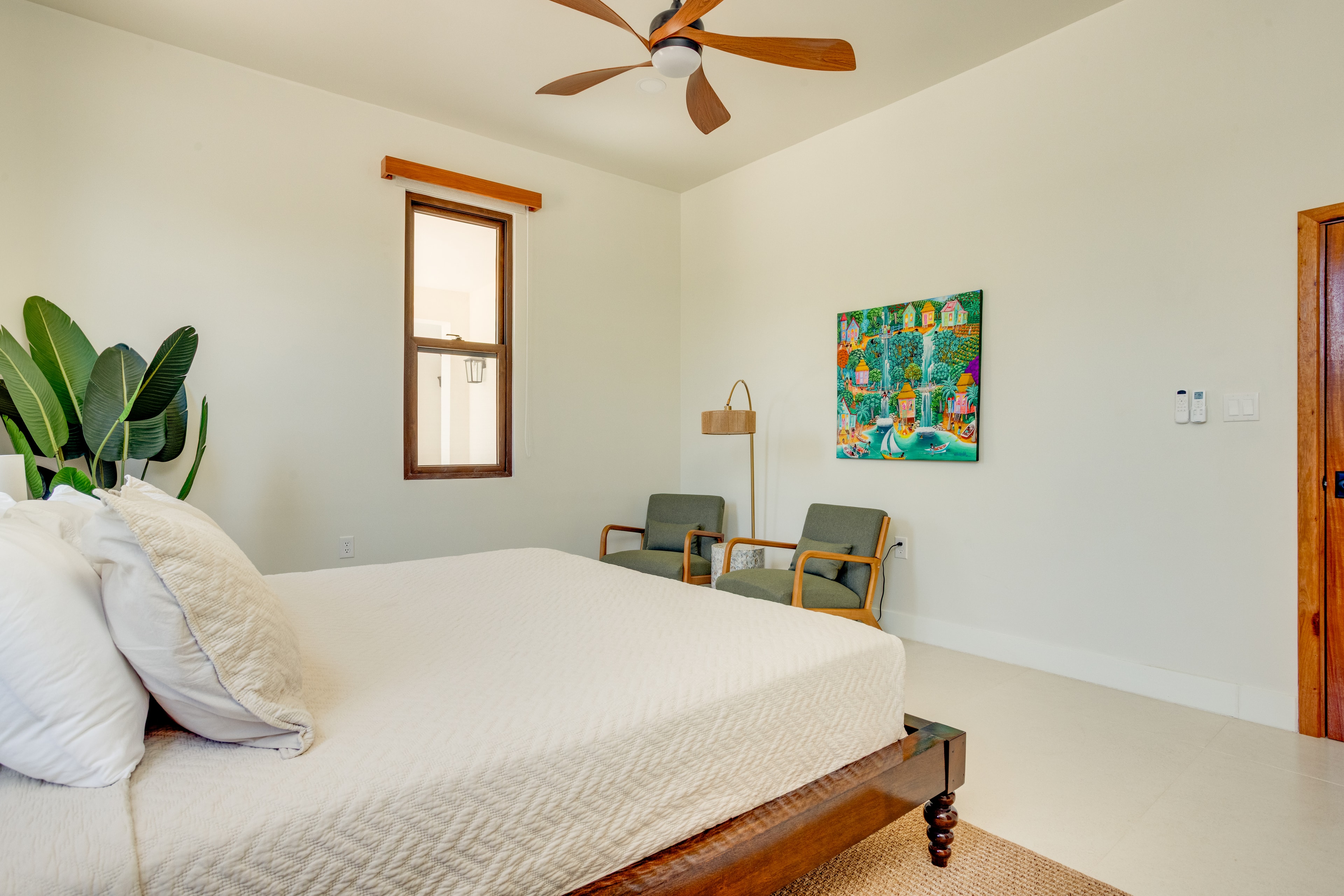 Master suite bedroom with ceiling fan