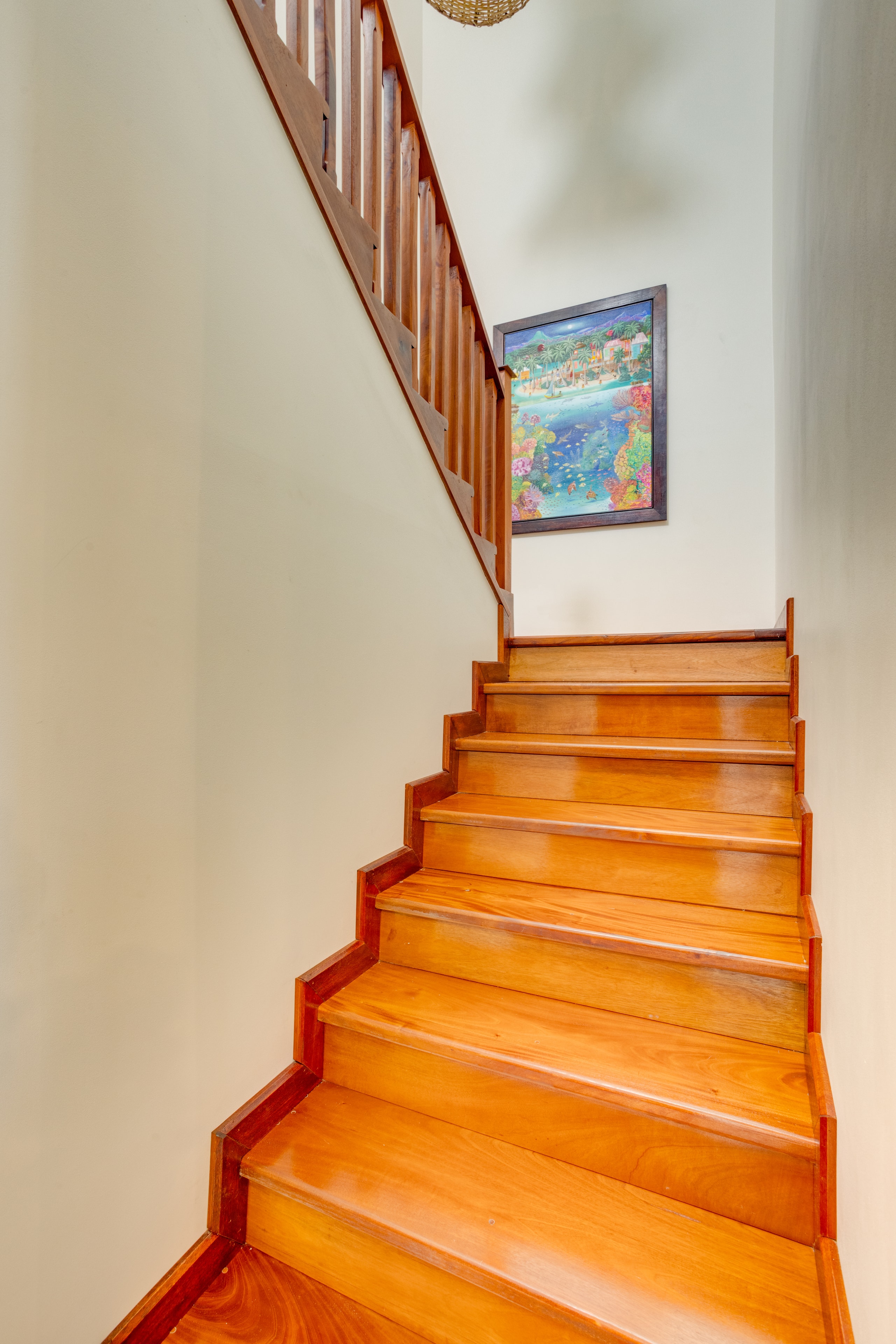 Hardwood staircase with Belizean artwork